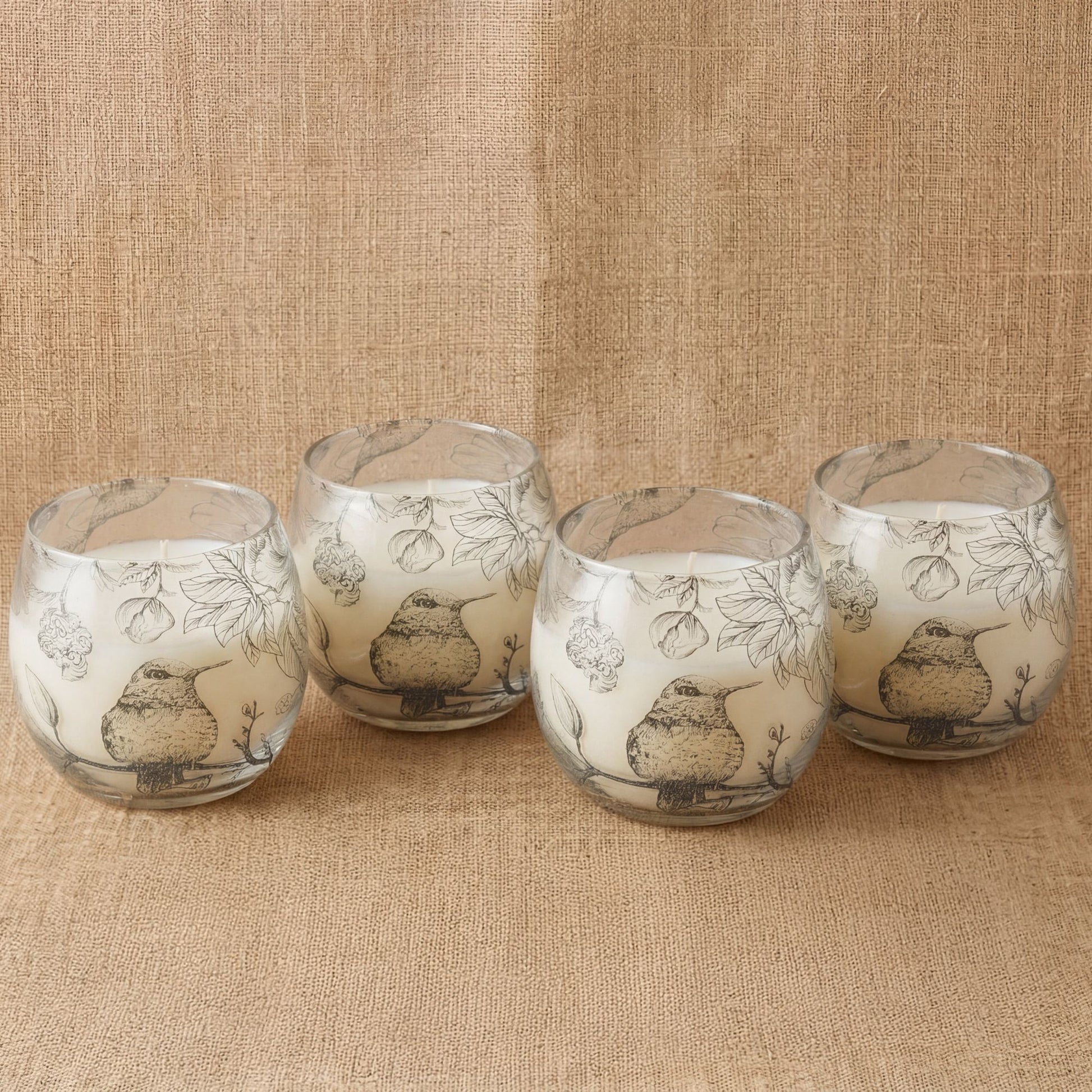 Detailed close up view highlighting the high quality craftsmanship and individual features of the small glass jar candles drawn by flame537