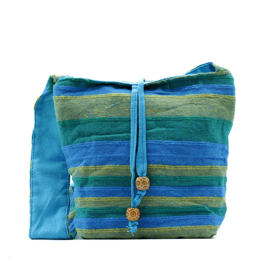 Nepal Sling Bag - Spring Meadows Green & Blue lifestyle product photo on neutral background