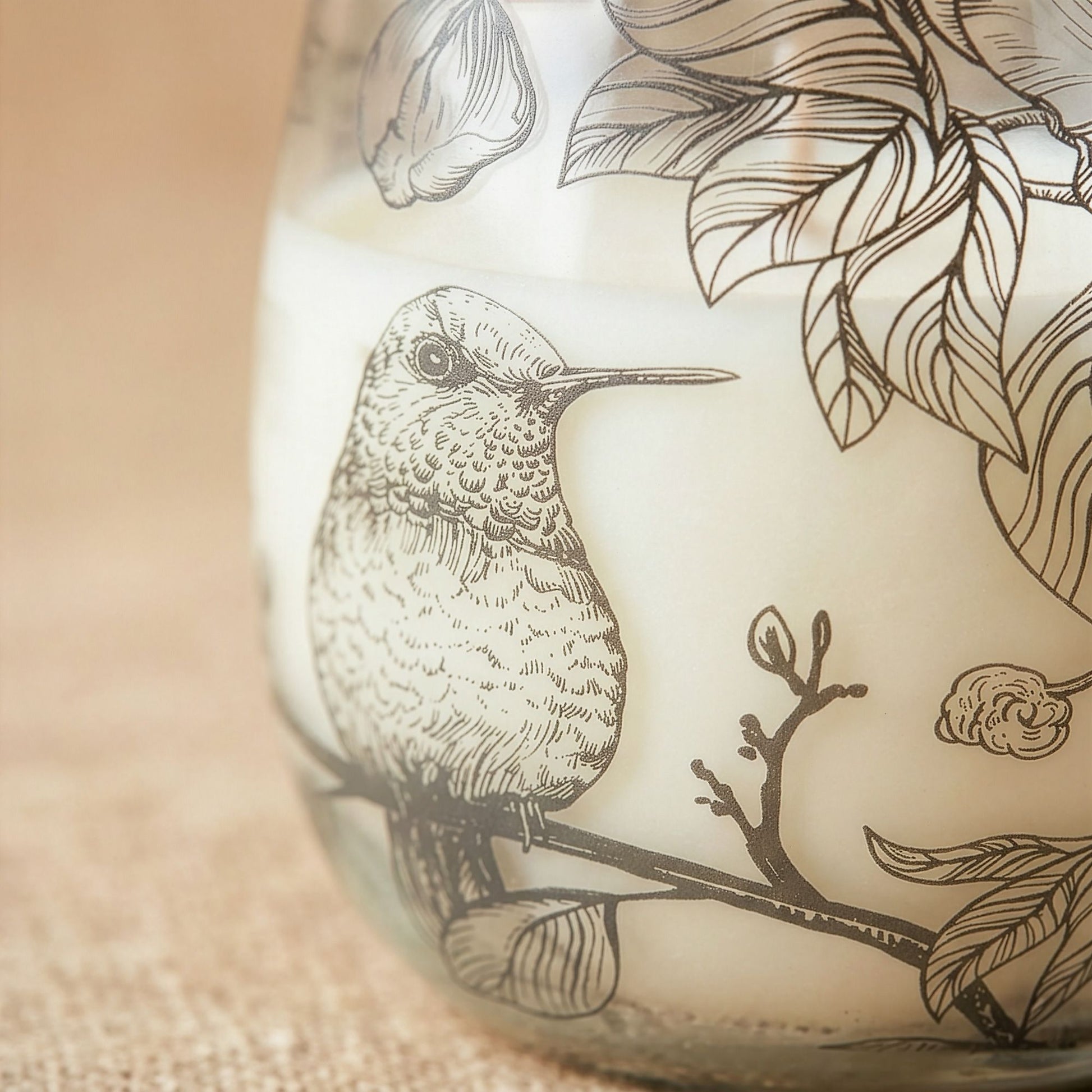 Detailed close up view highlighting the high quality craftsmanship and individual features of the medium glass jar candles drawn by flame385