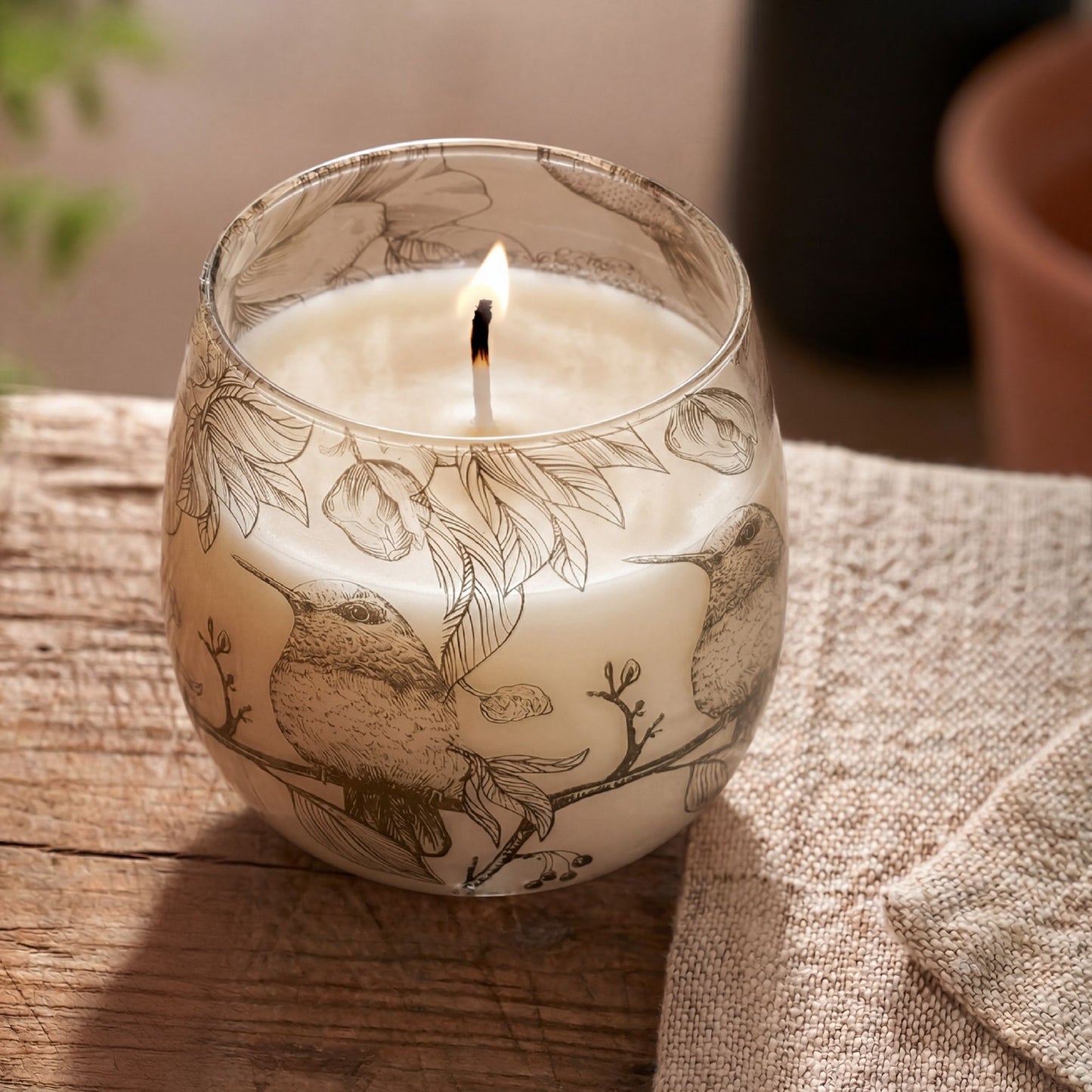 Detailed close up view highlighting the high quality craftsmanship and individual features of the medium glass jar candles drawn by flame385