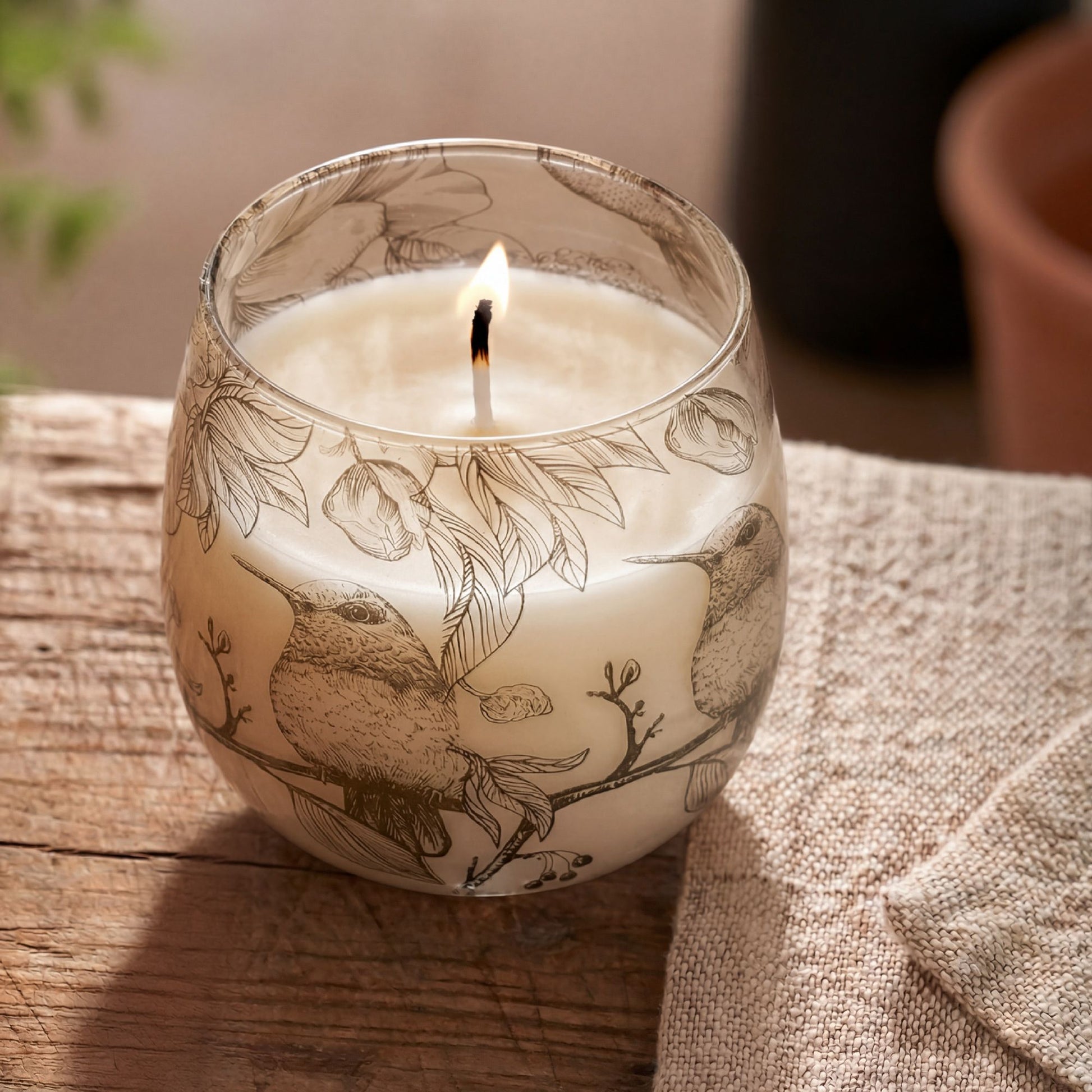 Detailed close up view highlighting the high quality craftsmanship and individual features of the medium glass jar candles drawn by flame385