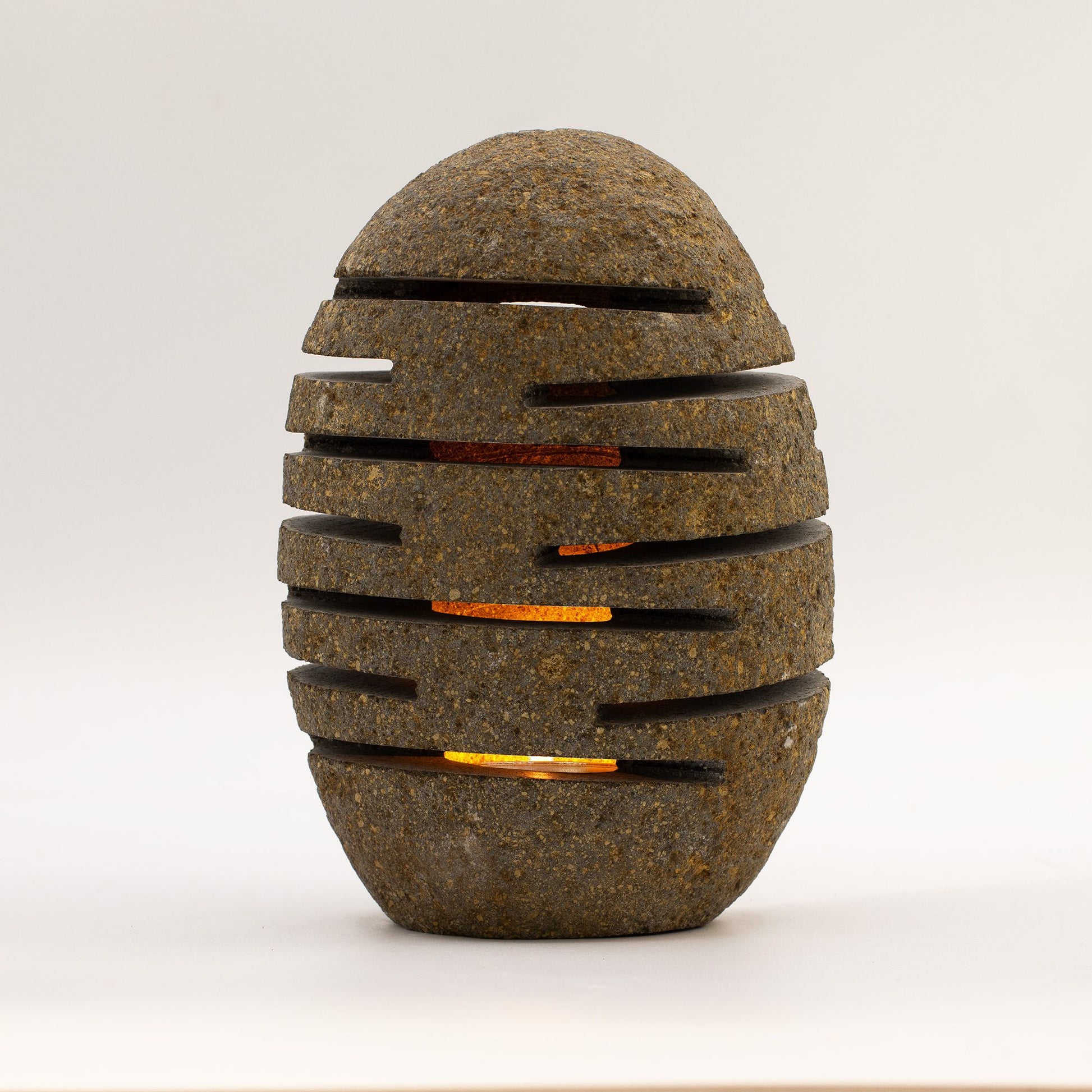 Detailed close up view highlighting the high quality craftsmanship and individual features of the natural riverstone candle holder standing stone cut 10x13x22cm543